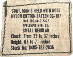 Original 1968 U.S. Army M-65 Field Jacket contract label showing DSA 100-68-C-2372, Appleman Mfg. Co., Small Regular, and Stock No. 8405-782-2936